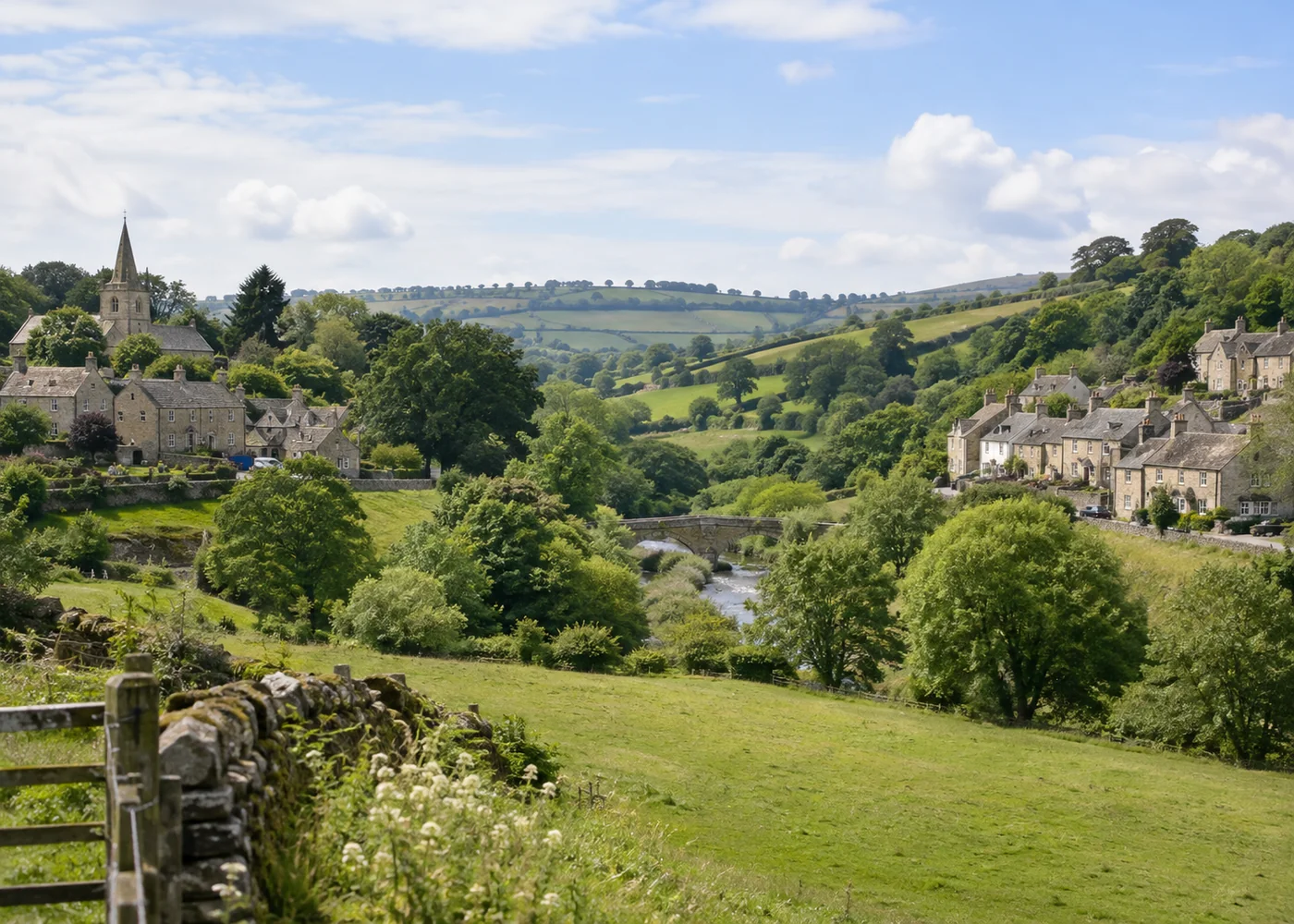 Two clusters of stone cottages across a green valley.