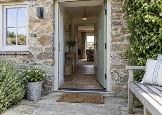 Level cottage entrance with wide open doorway.