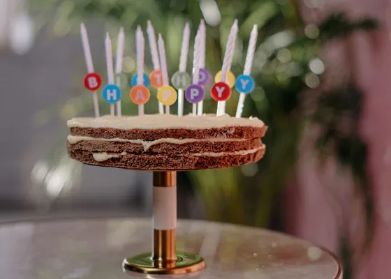 A small birthday cake decorated with colourful candles.