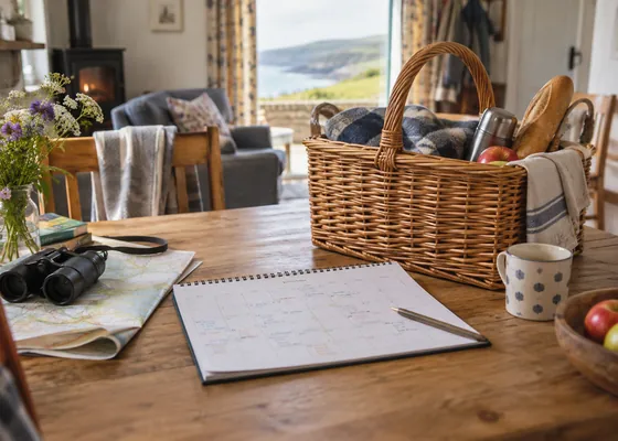 Family calendar and picnic basket on a table.